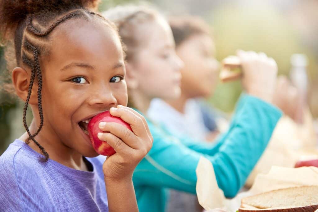 Child eating apple at school